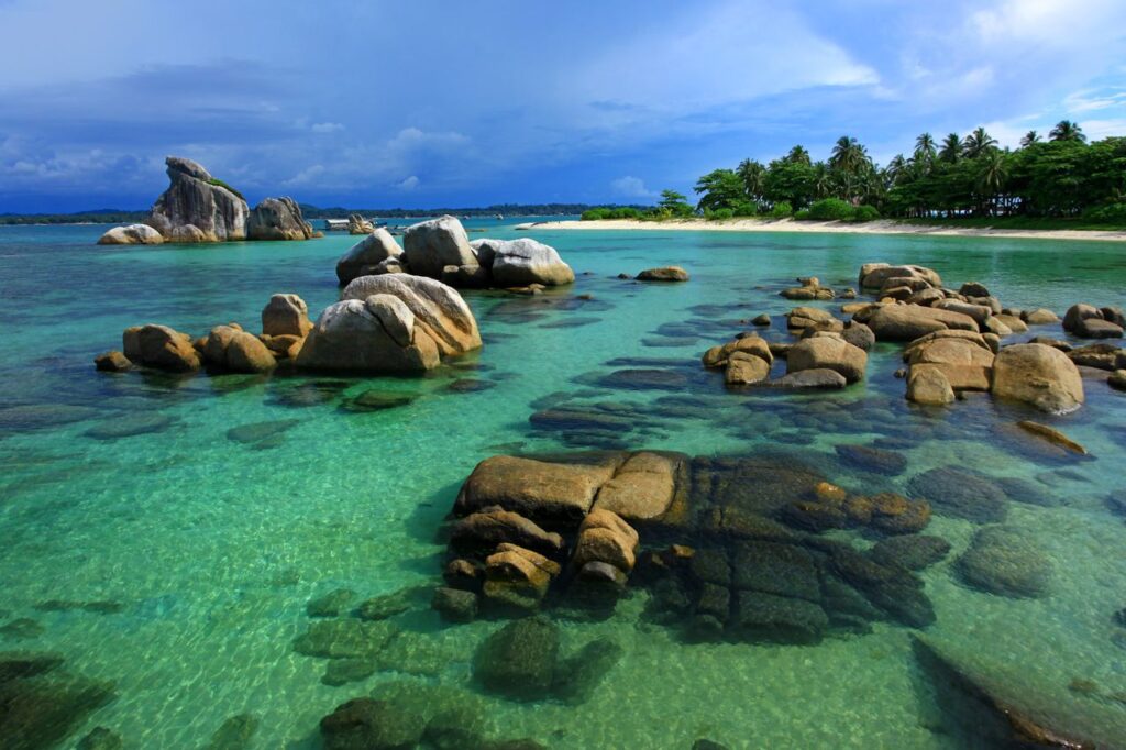 Experience the serene beauty of a tropical beach with unique rock formations and clear waters.